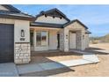 Inviting home showcasing stone details, modern windows, and stylish lighting fixtures at 13653 E Aloe Vera Dr, Scottsdale, AZ 85262