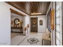 Bright foyer features tile flooring, skylight, wood ceiling and decorative wall art at 1859 N Morris --, Mesa, AZ 85201
