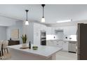 Modern kitchen with white cabinets, stainless steel appliances, and a center island with marble countertop at 1859 N Morris --, Mesa, AZ 85201