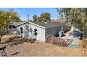 Rear view of the house showing a small yard and gated area at 2612 E Sandra Ter, Phoenix, AZ 85032