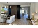 Bright dining room features a modern chandelier and table with seating for four at 10646 E Butherus Dr, Scottsdale, AZ 85255