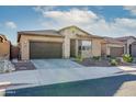 Charming single-story home featuring a desert landscape, stone accents, and a two-car garage at 23461 N 76Th Pl, Scottsdale, AZ 85255