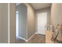Inviting foyer with a white entry door, neutral paint, and wood-look flooring at 23461 N 76Th Pl, Scottsdale, AZ 85255