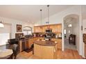 Kitchen featuring stainless appliances, a central island, and a view into the home's entry at 4506 E Lone Cactus Dr, Phoenix, AZ 85050