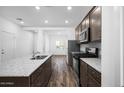 Modern kitchen with granite countertops, stainless steel appliances, and hardwood floors at 24586 W St Anne Ave, Buckeye, AZ 85326