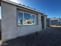 New home exterior with gray siding and large windows at 4301 E Bradford Ave, San Tan Valley, AZ 85143