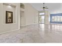 Open-concept living space with light tiled floors, neutral walls, and seamless flow to outdoor living at 16686 S 18Th Way, Phoenix, AZ 85048