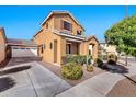 Two-story house with attached garage and desert landscaping at 2090 S Moccasin Trl, Gilbert, AZ 85295