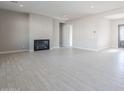 Spacious living room with tile flooring, fireplace, and large windows at 17640 W Guthrie St, Surprise, AZ 85388