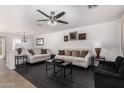 Bright living room featuring hardwood floors, neutral-toned furniture, and ample natural light at 8913 E Oro Cir, Mesa, AZ 85212