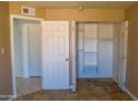 A bedroom with an open closet provides ample storage space at 2007 N 67Th Dr, Phoenix, AZ 85035