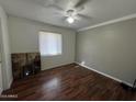 Bright bedroom with wood-look flooring and ceiling fan at 2007 N 67Th Dr, Phoenix, AZ 85035