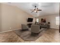 Inviting living room with neutral tones, ceiling fan, and stylish furniture arrangement at 44043 W Cypress Ln, Maricopa, AZ 85138