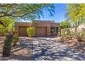 Lovely stucco home with two-car garage and mature trees at 9177 E Sunflower Ct, Scottsdale, AZ 85266