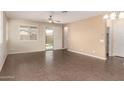 Spacious living area featuring tile floors, neutral paint, and slider door access to backyard at 10065 E Thatcher Ave, Mesa, AZ 85212