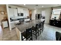 Spacious kitchen features granite countertops, white cabinetry, stainless steel appliances and large island at 5636 W Jackalope Ln, Laveen, AZ 85339