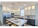 Beautiful kitchen showcasing a large island, stainless steel appliances, and stylish backsplash at 7750 E Broadway Rd # 723, Mesa, AZ 85208