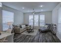 Bright living room featuring a comfortable sofa, ceiling fan, and large windows for natural light at 7750 E Broadway Rd # 723, Mesa, AZ 85208