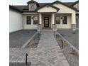 Inviting front entrance featuring a modern door, stone accents and well-maintained landscaping at 3888 E Weston Ln, San Tan Valley, AZ 85140