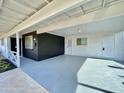 Spacious covered carport featuring painted concrete, a storage room, and access to the home at 2213 E Janice Way, Phoenix, AZ 85022