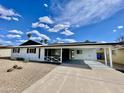 Charming single-story home featuring a covered carport and low-maintenance desert landscaping at 2213 E Janice Way, Phoenix, AZ 85022