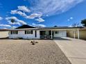 Charming single-story home featuring a covered carport and low-maintenance desert landscaping at 2213 E Janice Way, Phoenix, AZ 85022