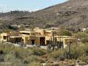 Aerial view of a large house under construction in a desert setting at 10023 E Filaree Ln, Scottsdale, AZ 85262