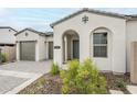 Beautifully landscaped home featuring a stone driveway, a two-car garage, and an arched entryway at 17643 W Middlebury St, Surprise, AZ 85388