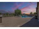 Expansive brick-paved backyard featuring a luxurious pool, spa, and an outdoor seating area at 3414 E Virgil Dr, Gilbert, AZ 85298