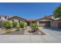 Charming single-story home with desert landscaping, brick walkway, and attached two-car garage at 3414 E Virgil Dr, Gilbert, AZ 85298
