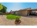 Artificial turf lawn, covered patio, and storage shed in backyard at 6908 W Sunnyside Dr, Peoria, AZ 85345