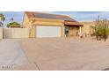 Long driveway leads to a two-car garage with a large, flat parking area at 6908 W Sunnyside Dr, Peoria, AZ 85345