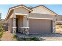 Home exterior featuring a two-car garage, desert landscaping, and front entry at 5664 N 205Th Ln, Buckeye, AZ 85396