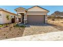 Charming home with an attached two-car garage, neutral stucco, and xeriscaping at 5664 N 205Th Ln, Buckeye, AZ 85396