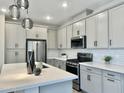 Modern kitchen with stainless steel appliances and an island at 746 E Doral Ave # 201, Gilbert, AZ 85297