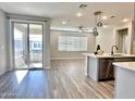Open living area with sliding glass doors leading to a balcony at 746 E Doral Ave # 201, Gilbert, AZ 85297