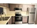 Updated kitchen features stainless steel appliances and ample cabinetry at 1319 E Marny Rd, Tempe, AZ 85288
