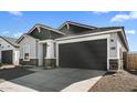 Angle of single-story house with gray-colored 2-car garage and desert landscaping at 16555 N Lunar St, Maricopa, AZ 85138