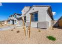 A clean shot of the exterior corner of a modern-style home with desert-style landscaping at 18440 W Monte Lindo Ln, Surprise, AZ 85387