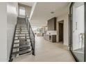 Modern entryway with open staircase, light wood floors, and views of the living area at 4414 N 29Th St, Phoenix, AZ 85016