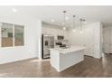 Bright kitchen featuring an island, stainless steel appliances, and white cabinetry at 11624 W Beck Dr, Youngtown, AZ 85363