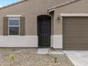 Close up exterior shot of a single Gathering home showcasing the front door at 16001 W Cottontail Ln, Surprise, AZ 85387