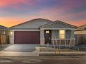 An attractive home in a well manicured neighborhood, as seen at sunset at 16005 W Cottontail Ln, Surprise, AZ 85387