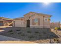 Modern one-story house with stone accents and a desert landscape at 18955 W Ocotillo Rd, Waddell, AZ 85355
