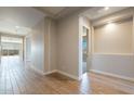 Bright hallway with wood-look tile flooring and recessed lighting at 18955 W Ocotillo Rd, Waddell, AZ 85355