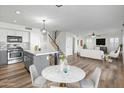 Open floor plan showcasing kitchen island, stainless steel appliances, and spacious living area at 20722 N 38Th St, Phoenix, AZ 85050