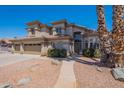 Stunning two-story home with a three-car garage, a tile roof, desert landscaping and attractive curb appeal at 1663 S Boulder St, Gilbert, AZ 85295