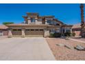 Beautiful two-story home with a three-car garage, desert landscaping and a welcoming front entrance at 1663 S Boulder St, Gilbert, AZ 85295