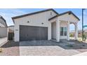 Charming single-story home featuring a grey roof, well-manicured yard and stylish modern farmhouse architecture at 4405 N 203Rd Ave, Buckeye, AZ 85396