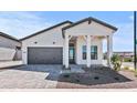 Charming single-story home featuring a grey roof, well-manicured yard and stylish modern farmhouse architecture at 4405 N 203Rd Ave, Buckeye, AZ 85396